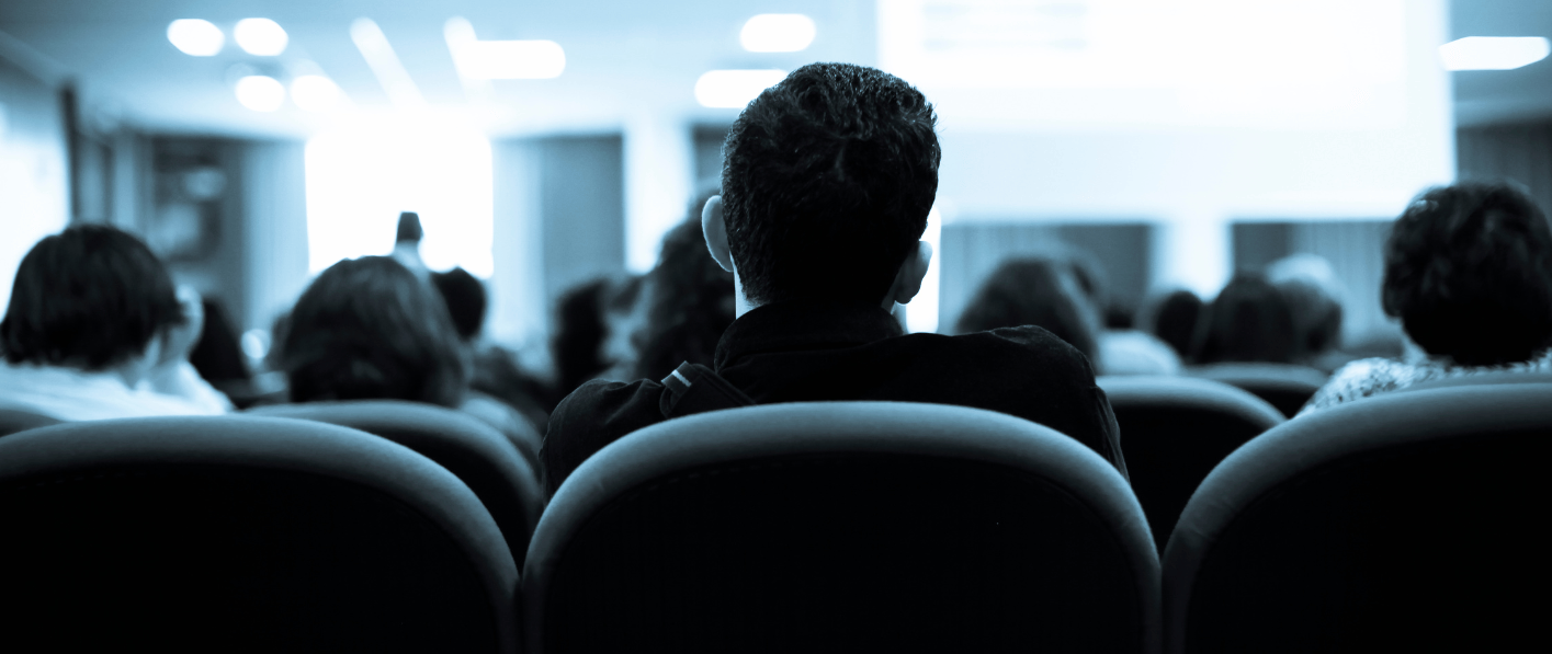 man looking at someone presenting at a training session
